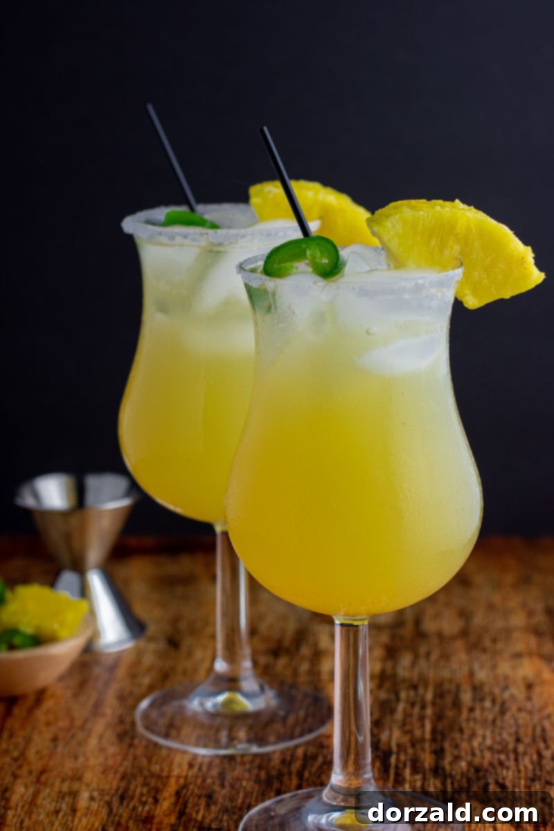 Fiery Sweet Siren 5 two glasses in cocktails with ice pineapple jalapeño