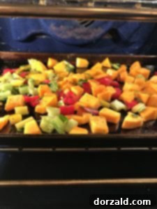 butternut squash and swiss chard stems seasoned and ready for oven roasting