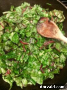 sautéing shallots and garlic with swiss chard leaves for gratin