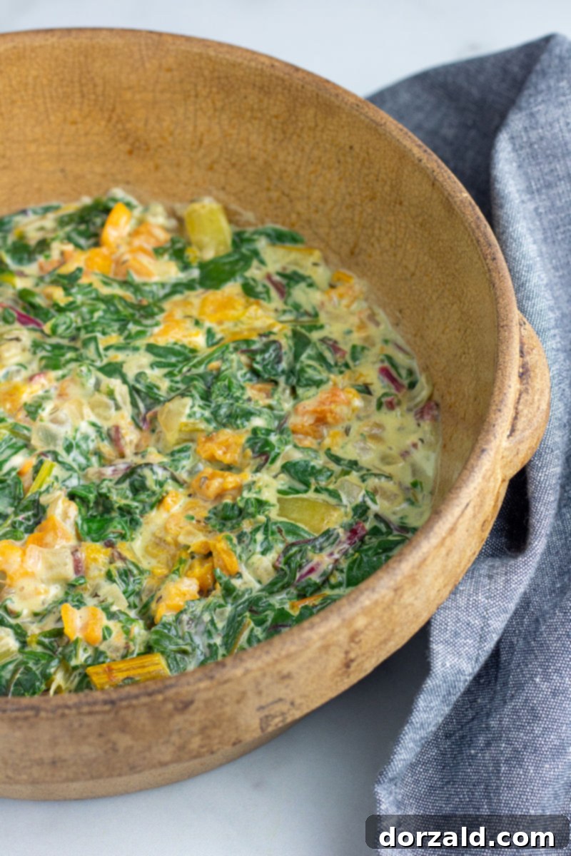 close up of creamy dairy-free swiss chard and butternut squash gratin before baking