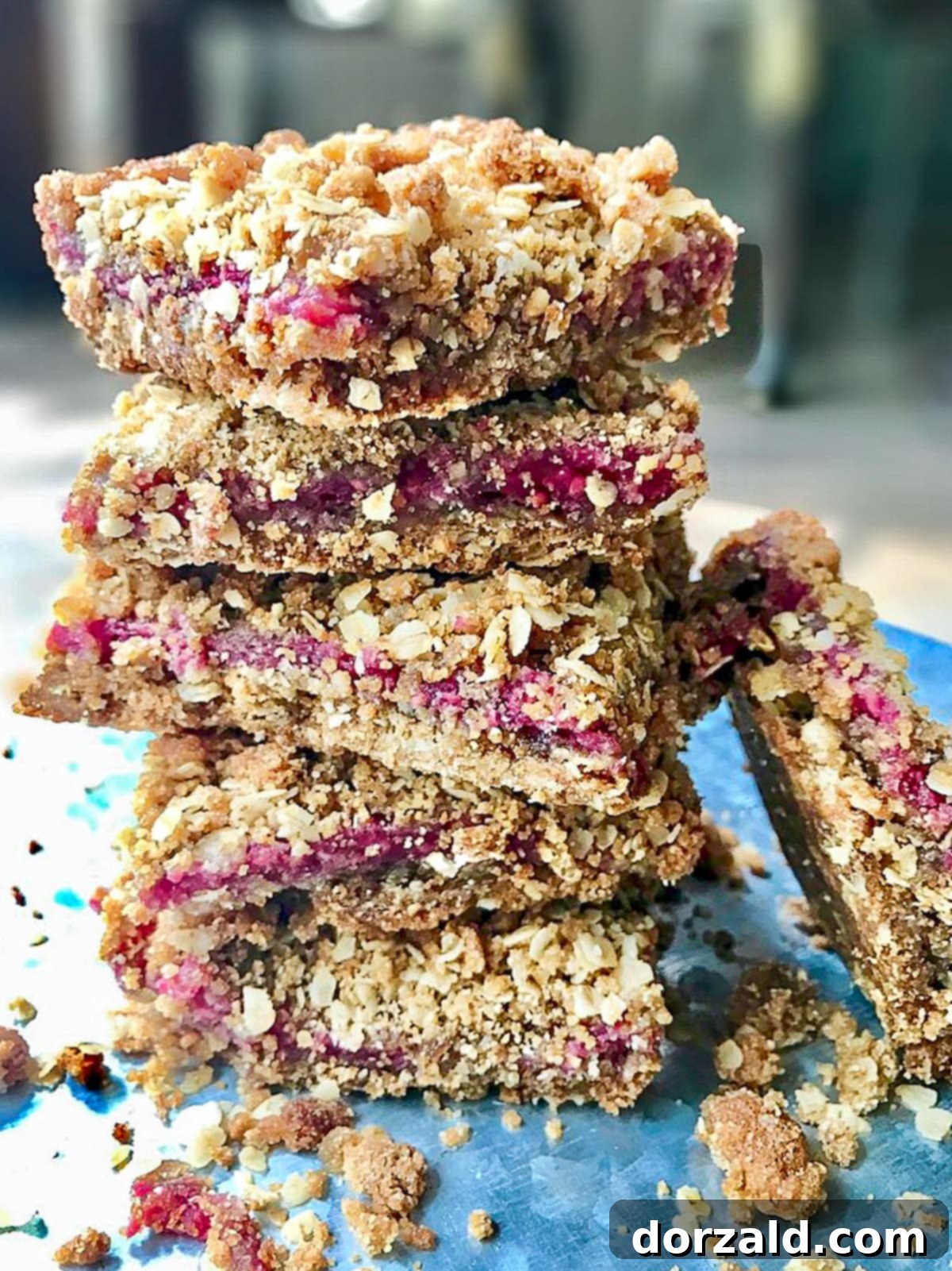 Luscious Gluten-Free Vegan Raspberry Bars 7 Baked gluten-free raspberry bars in a square baking pan, ready to be cut