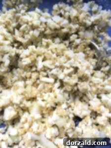 mixing ingredients for cauliflower tots in a bowl