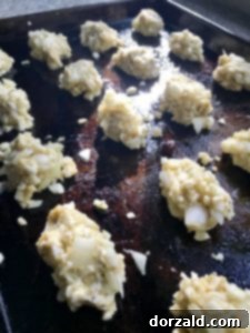 forming and placing cauliflower tots on baking sheet for baking