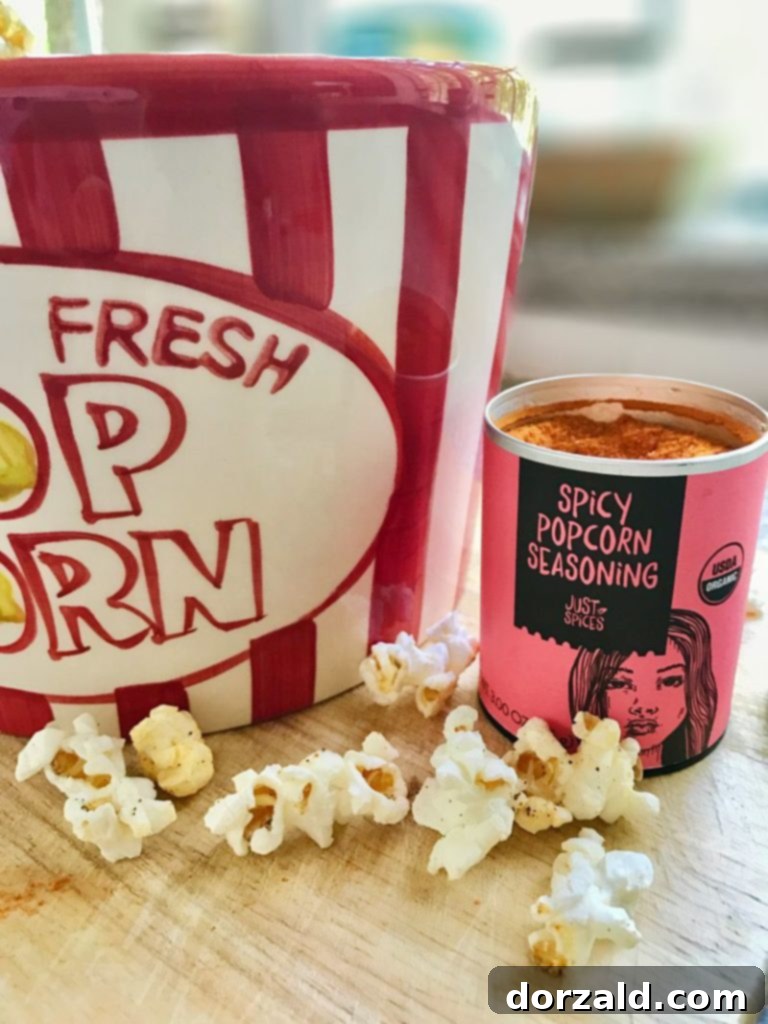 Spicy Popcorn with seasoning being added