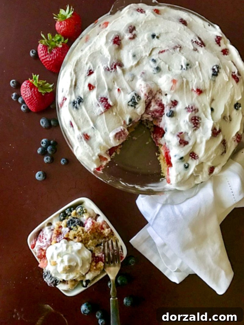 Luscious Gluten-Free Dairy-Free Berry Tart 2 Overhead view of a whole gluten-free dairy-free berry tart, with one piece cut out and in a white dish.