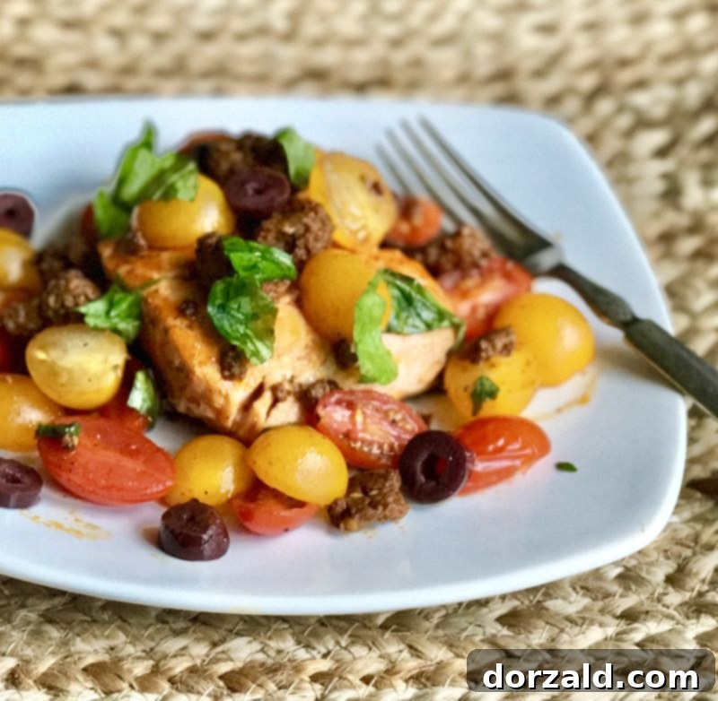 Three individual servings of Tomato Chorizo Salmon on white plates, ready to eat