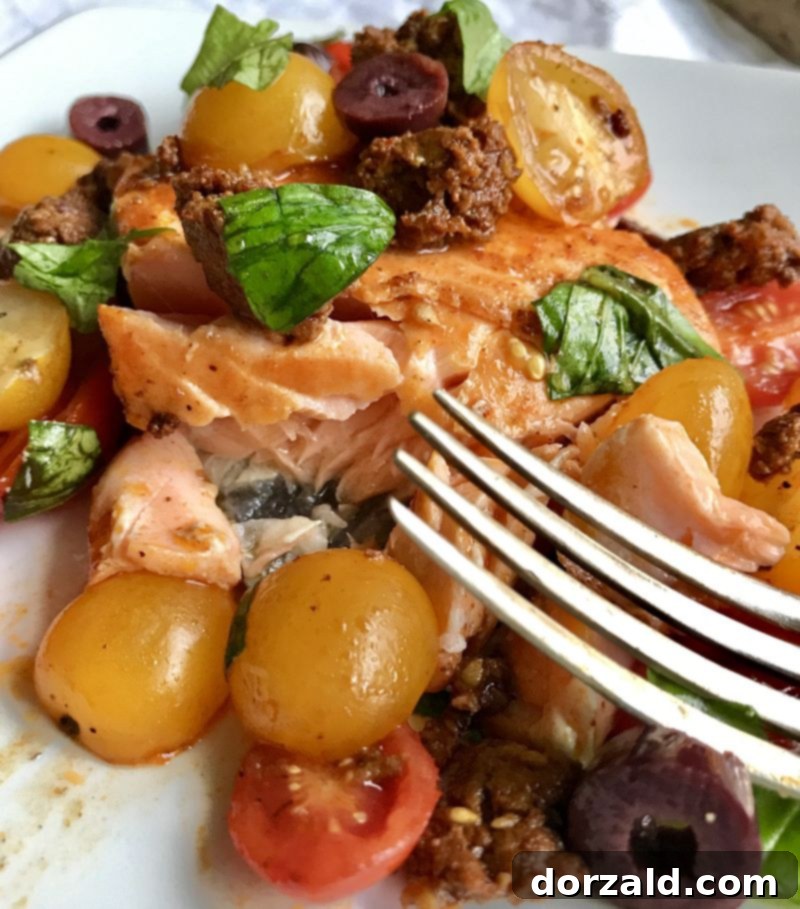 Jamie Oliver Inspired Tomato Chorizo Salmon with fresh basil, tomatoes, and chorizo on a cutting board