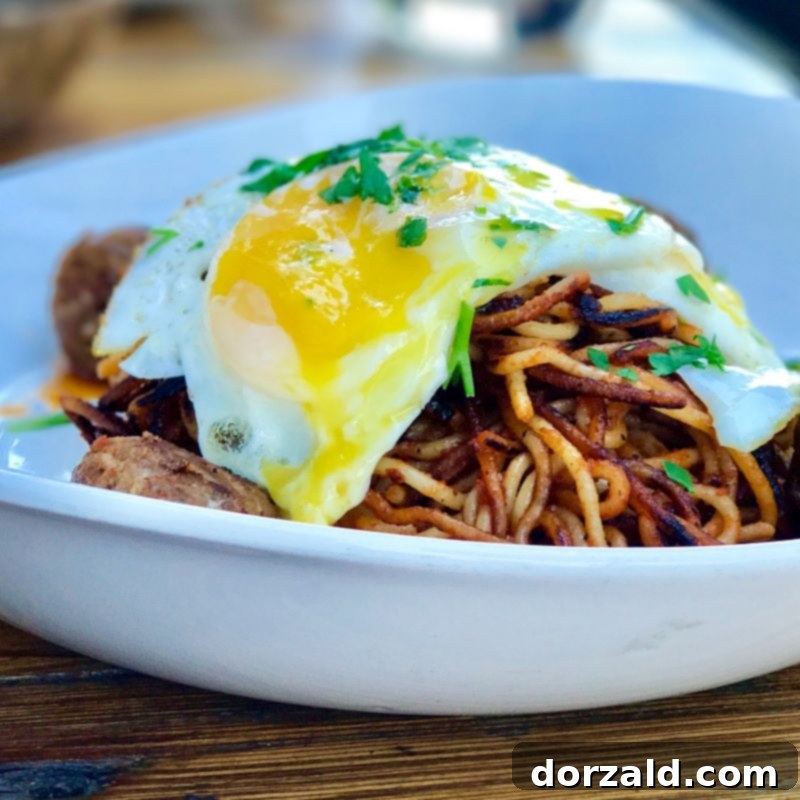 Stock and Barrel Dallas Review 2 A beautifully presented brunch spread at Stock and Barrel Dallas, featuring two main dishes and drinks.