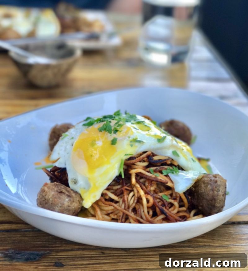 Stock and Barrel Dallas Review 3 Close-up of the Fried Spicy Spaghetti dish with Wagyu meatballs and fried eggs at Stock and Barrel.