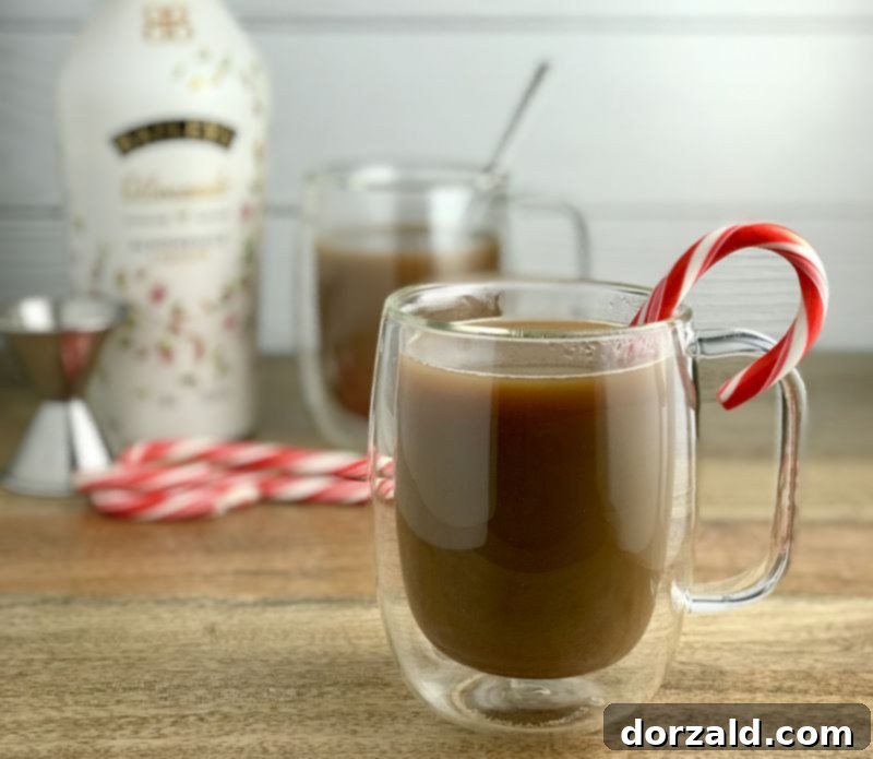 dairy-free baileys cream and coffee swirling in a glass mug, a cozy holiday drink
