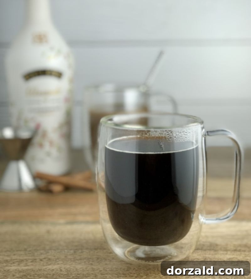 Pouring dairy-free Baileys almond milk liqueur into coffee
