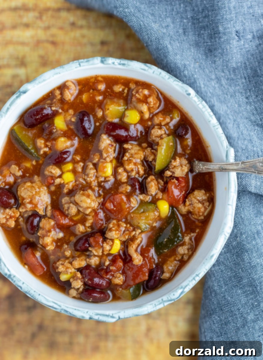 Close-up of the rich, chunky texture of Vegetable Turkey Chili in a large pot, ready to be served.