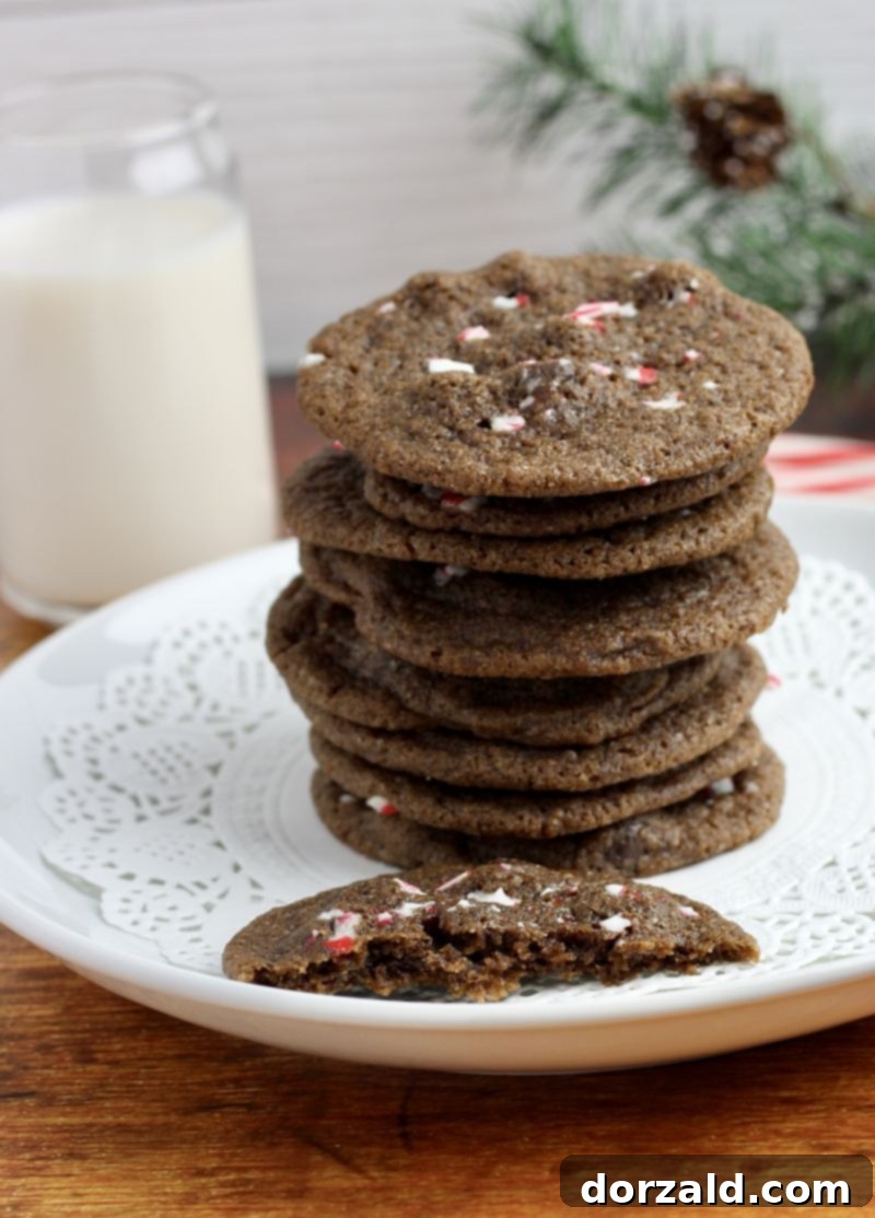 Chewy mint chocolate chip peppermint holiday cookies, adorned with crushed candy canes, from Kitchen Gone Rogue.
