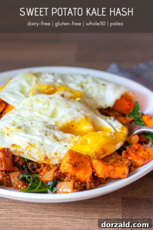 chorizo sweet potato kale hash breakfast with eggs on white plate