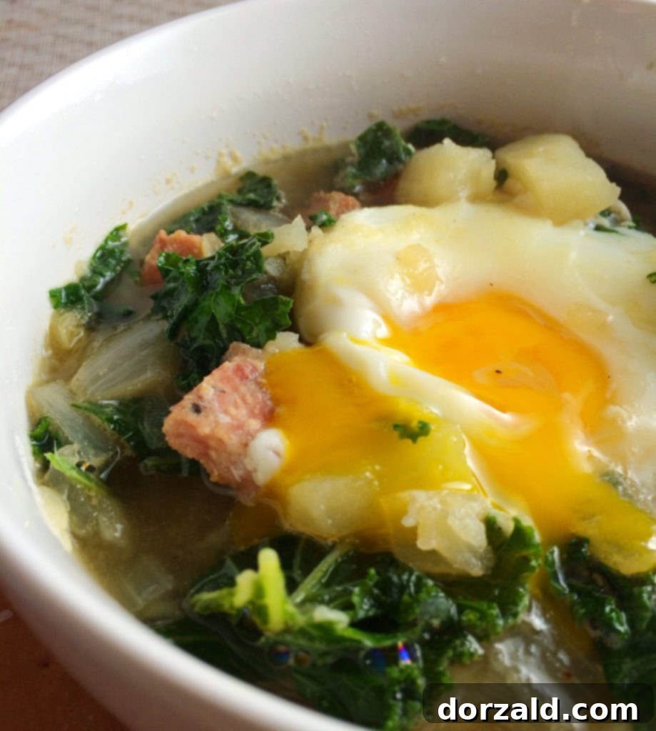 A bowl of rich Zuppa Toscana soup, brimming with sausage, kale, and potatoes in a creamy broth.