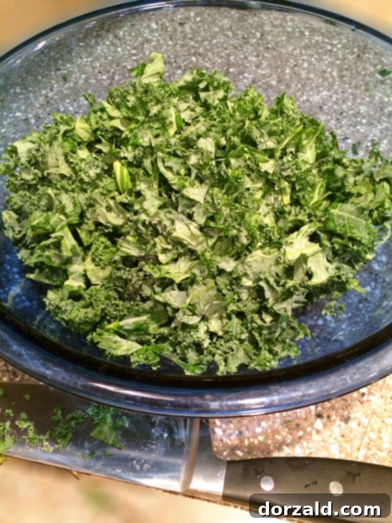 A healthy and light potato kale soup topped with a perfectly poached egg, ready to be enjoyed.