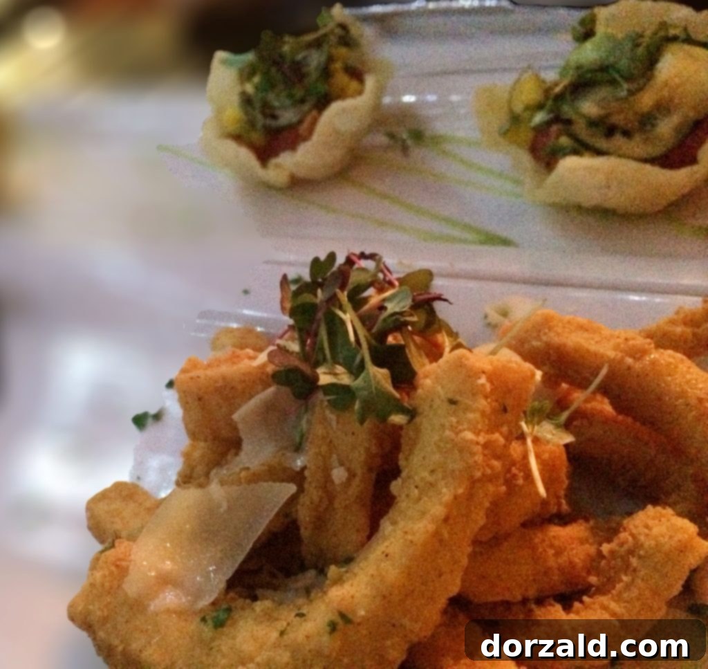 Delicious Calamari Fries with sweet and spicy chili sauce and Ahi Tuna Wontons at The Woolworth Dallas, ready to be enjoyed.