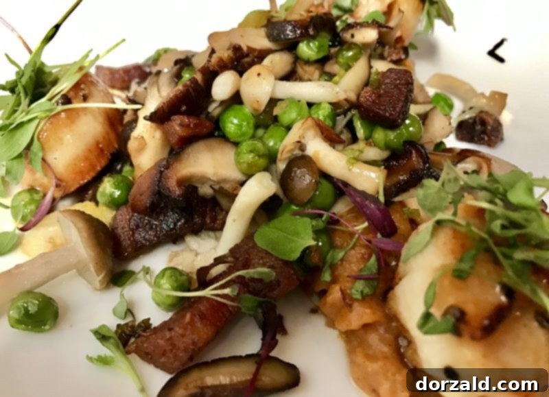 Perfectly seared scallops with sweet potato puree and colorful vegetables at The Woolworth Dallas restaurant.