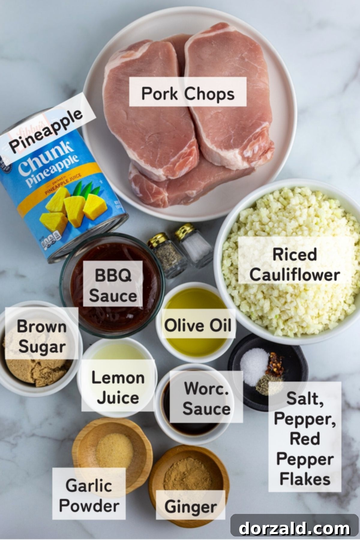 Close-up of fresh pineapple chunks and uncooked pork chops, ready for cooking