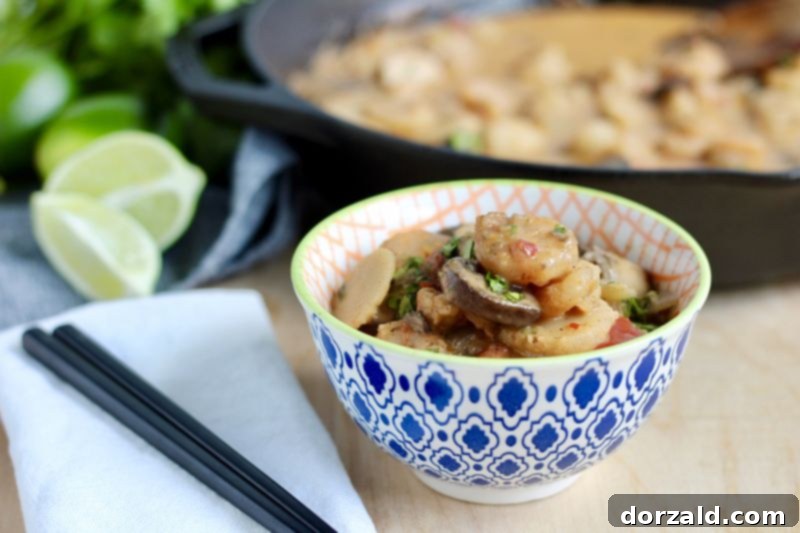 Succulent Creamy Red Chili Shrimp Stir Fry 4 Close-up of Creamy Red Chili Shrimp Stir Fry in a pan, garnished with cilantro
