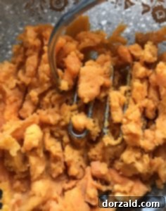 Sweet potatoes with holes poked, ready for microwaving