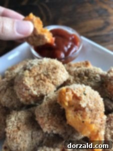 Baked sweet potato tots served with ketchup and hot sauce