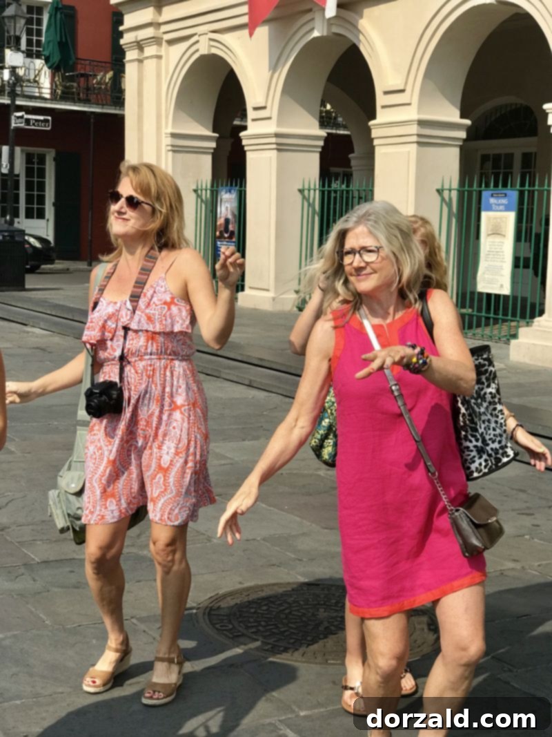 Tour participants dancing joyfully to live music in Jackson Square New Orleans