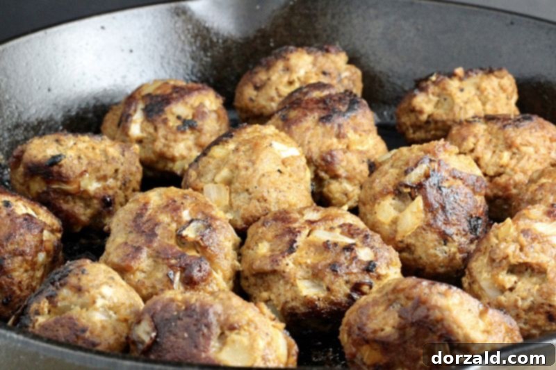 Spicy Turkey Chorizo Meatballs 7 A close-up of a single turkey chorizo meatball, showcasing its tender texture and appealing color.