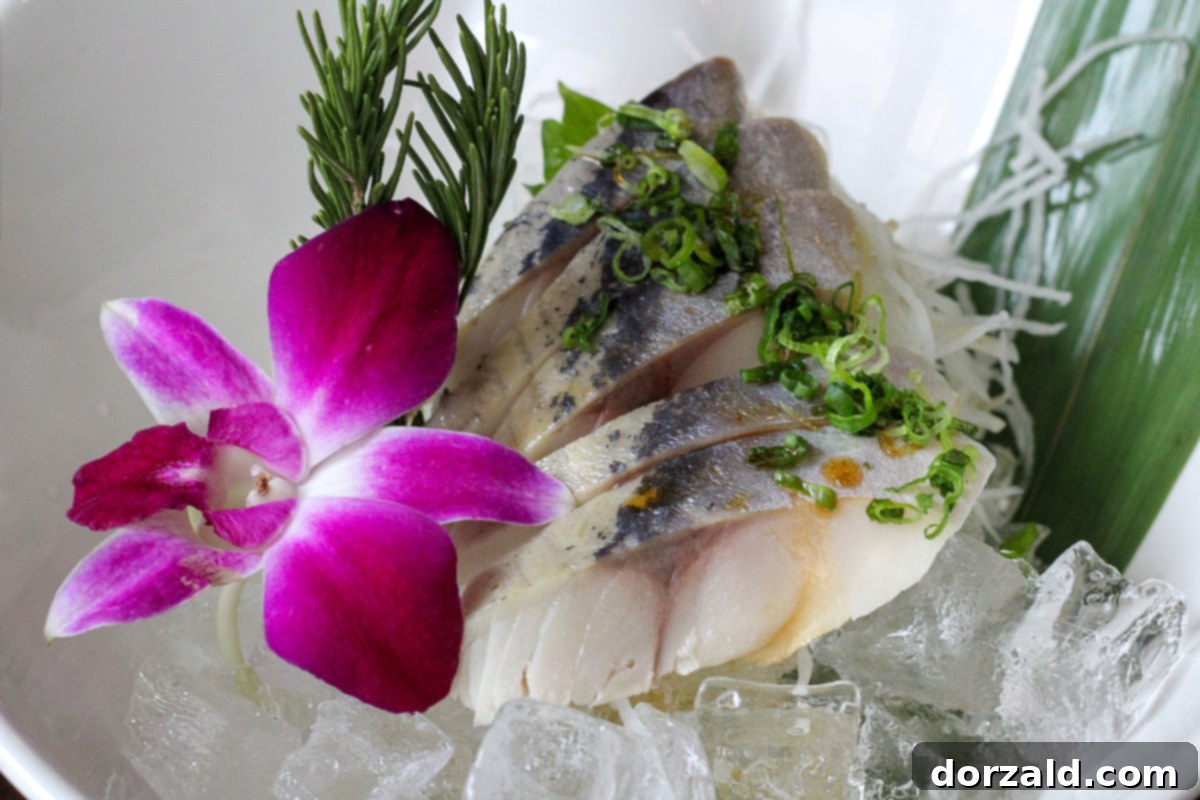 5 pieces of mackerel sashimi served with a sprig of rosemary chopped scallions and edible flower at Edoko - photo by Kelly Kirkendoll