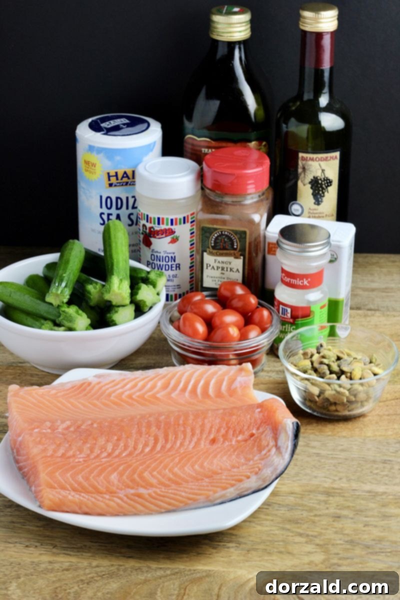 fresh ingredients for pistachio salmon: salmon, baby zucchini, pistachios, cherry tomatoes, salt, pepper, paprika, olive oil, balsamic vinegar