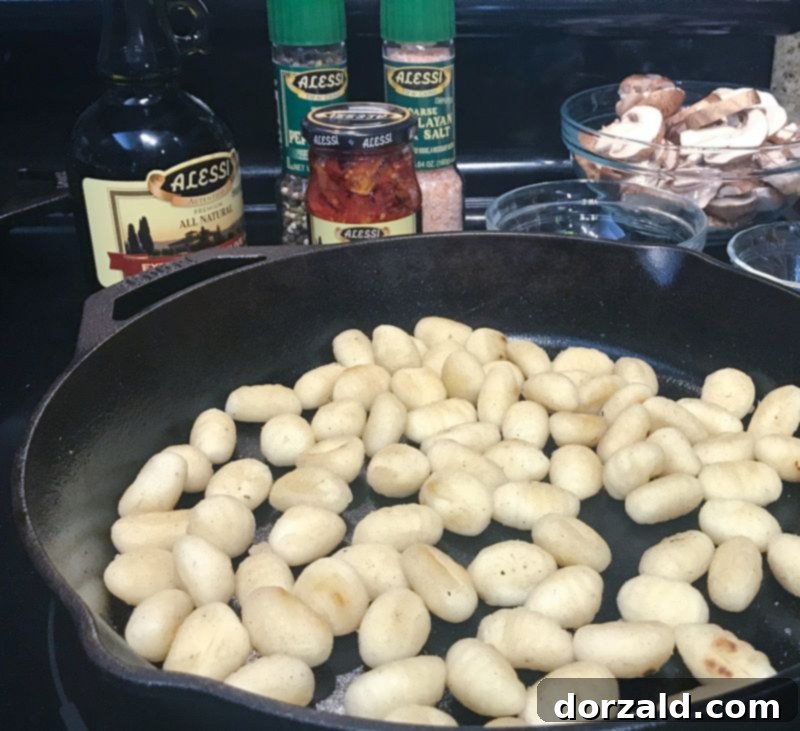 pan-fried gnocchi in cast iron skillet with ingredients
