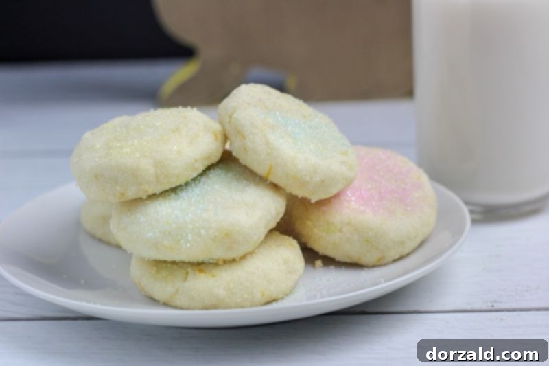 Coconut Lemon Shortbread Cookies on Plate with cup of Almond Milk