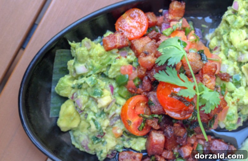 El Bolero Crockett Row: Restaurant Review 7 Close-up of bacon guacamole with fresh ingredients including cherry tomatoes at El Bolero Crockett Row