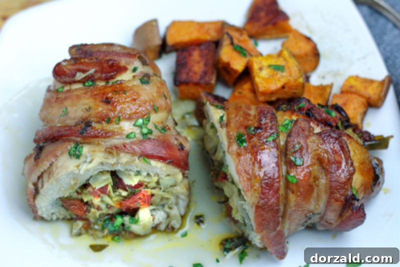 Bacon Wrapped Veggie Stuffed Chicken on White Plate ready to eat