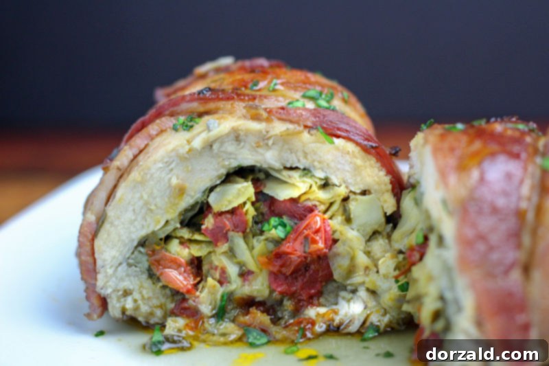 Bacon Wrapped Veggie Stuffed Chicken cut in half showing veggies inside