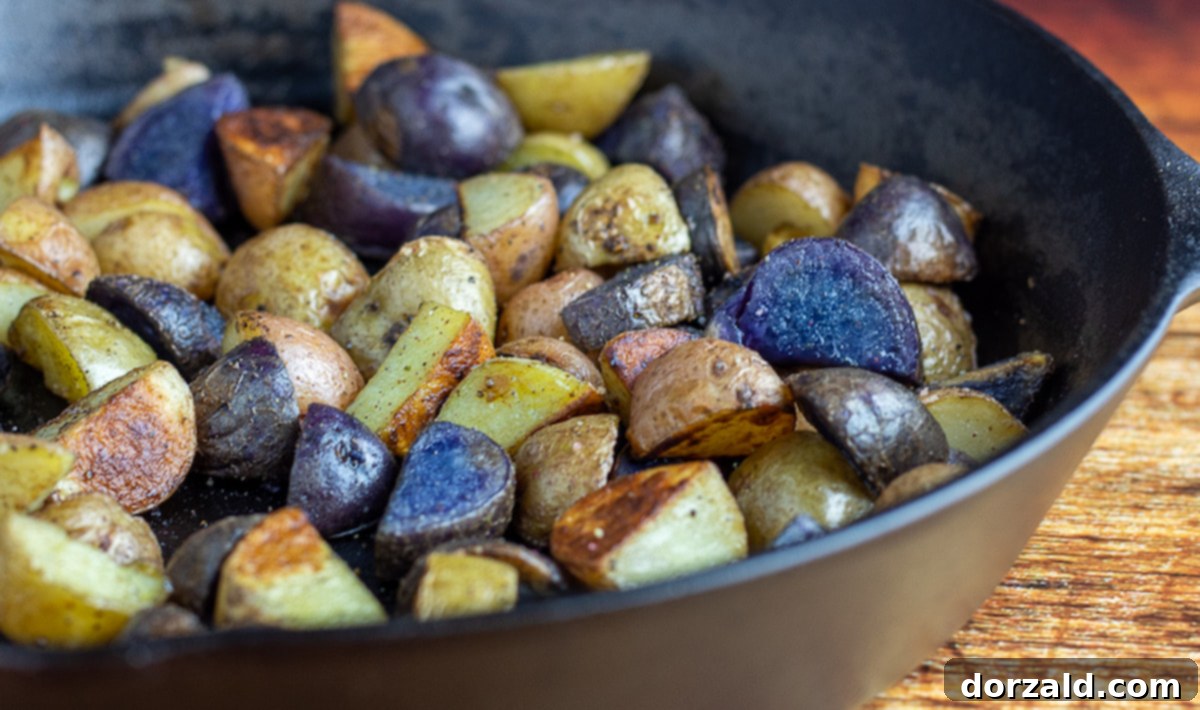A close-up shot of crispy skillet roasted baby potatoes in a cast iron pan, ready to be served.