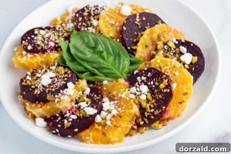 Orange Beet Salad topped with pistachios and sesame seeds