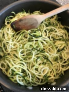 Sautéing zucchini noodles until tender