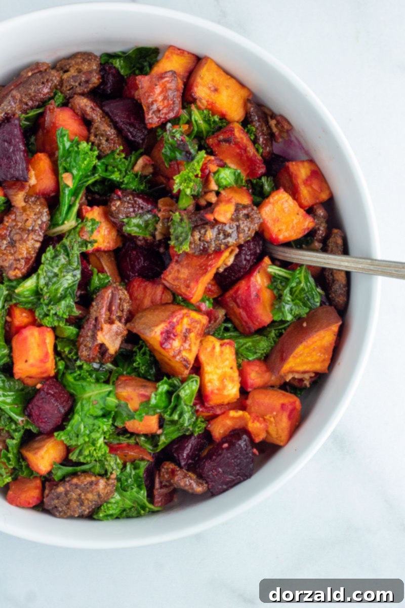 Candied Pecan Kale Salad with Sweet Potato and Beets 2 Vibrant Roasted Sweet Potato, Beet, and Kale Salad with Candied Pecans in a elegant white bowl, garnished