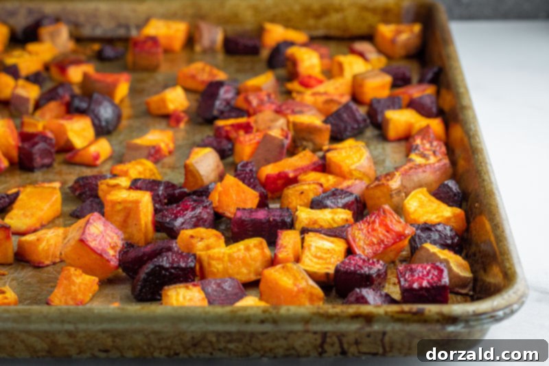 Candied Pecan Kale Salad with Sweet Potato and Beets 4 Cubed sweet potatoes and beets roasting on a sheet pan, ready for the salad