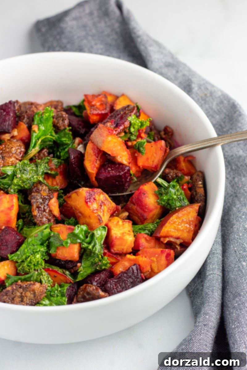 Candied Pecan Kale Salad with Sweet Potato and Beets 5 Sweet Potato Beet Kale Salad with Candied Pecans in a white serving bowl with a spoon