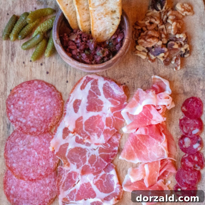 A lavish charcuterie board featuring an assortment of meats, cheeses, pickles, and bread, served at Checkered Past Winery in Dallas.