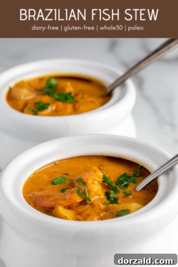 Brazilian fish stew - Moqueca in a bowl with a fork, ready to eat. Keywords: whole30, paleo, fish stew, brazilian food, moqueca, pescatarian recipe, dairy-free, gluten-free, soy-free.