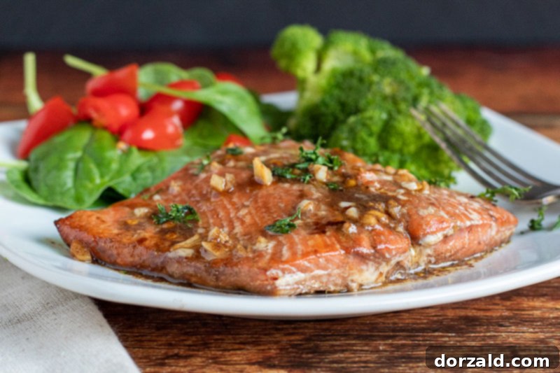 Ingredients for salmon marinade laid out on a wooden board: olive oil, soy sauce, balsamic vinegar, brown sugar, garlic, and spices.