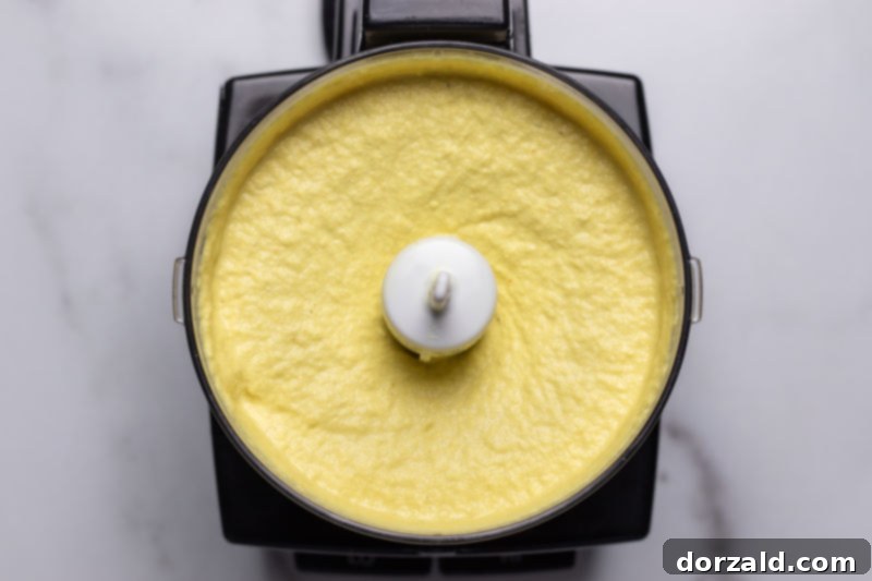 Blending the dairy-free cashew cheese sauce ingredients for a smooth consistency