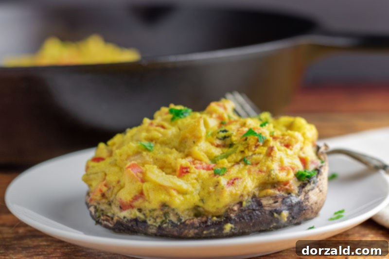Vegan stuffed portobello mushrooms topped with dairy-free cashew cheese sauce