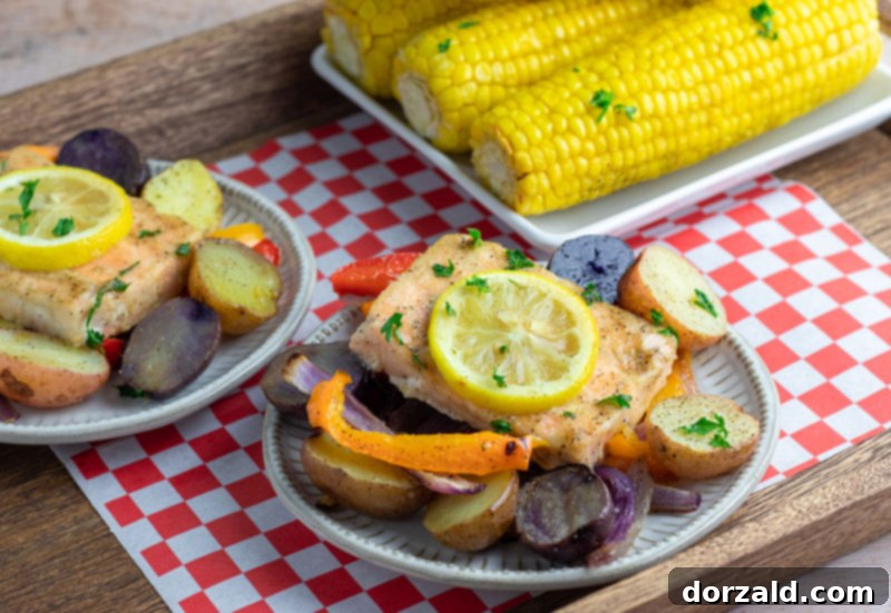 Easy One-Pan Roasted Salmon and Veggies 6 Plates of roasted salmon and vegetables with corn on the cob