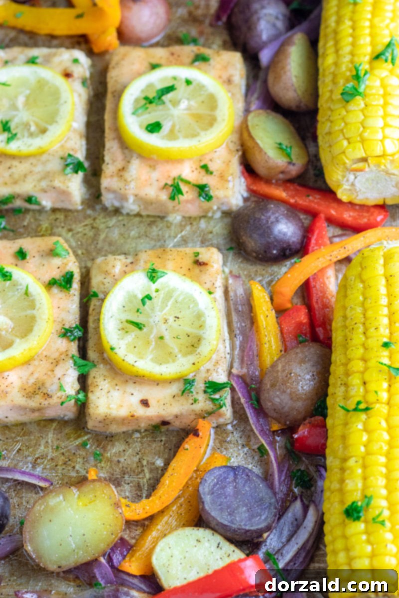 Easy One-Pan Roasted Salmon and Veggies 7 Sheet pan with roasted salmon, vegetables, and corn on the cob