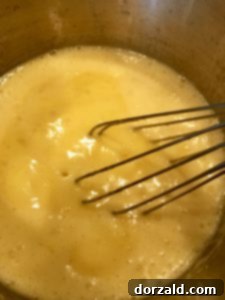 Zesty Vegan Lemon Curd 11 Dairy-free lemon curd thickening in a saucepan on low heat.