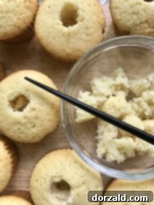 Cored cupcake piece being removed from corer